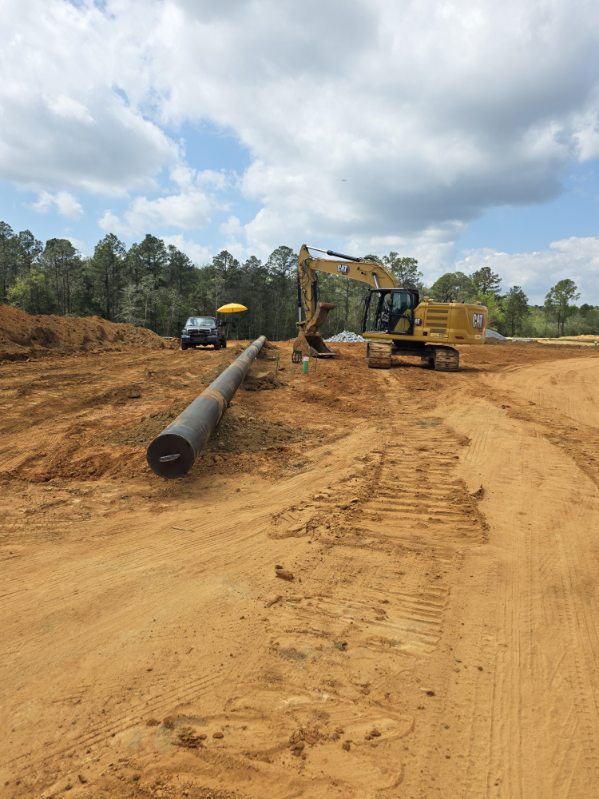 Large-diameter pipeline installation with excavator